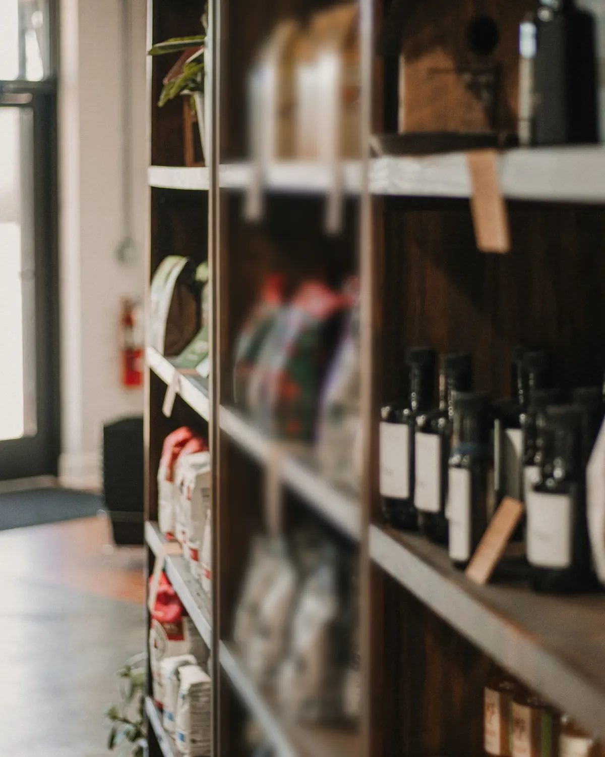 Packaged food and bottled goods on wooden retail shelving
